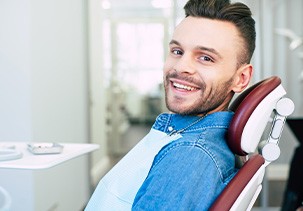 Patient smiling while sitting in treatment chair