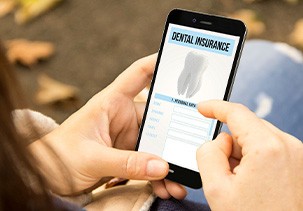 A woman looking at a dental insurance app