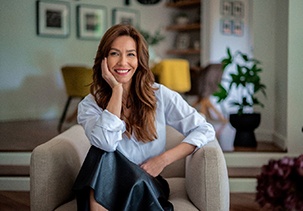 Confident woman with beautiful smile, sitting in armchair