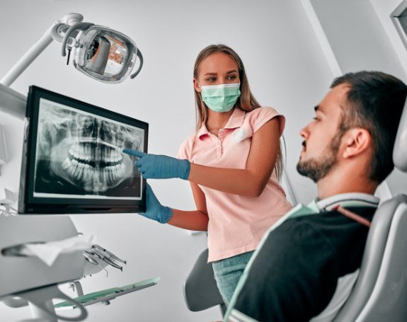 Dentist and patient discussing tooth extractions