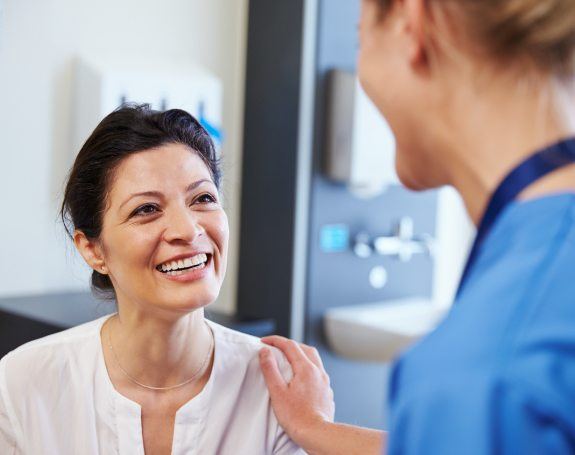 Woman talking to dentist about common dental emergencies