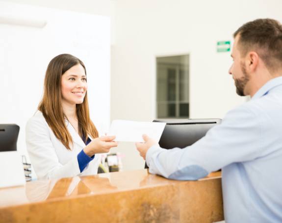 Dental team member explaining the cost of dental implants