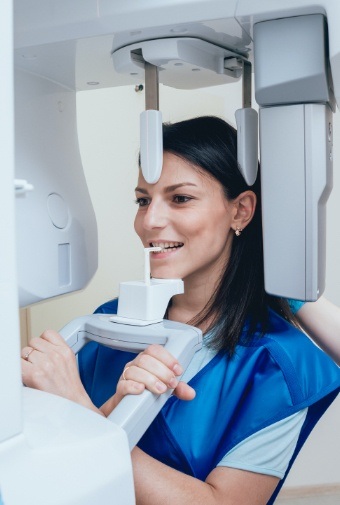 Woman receiving 3 D C T cone beam x-ray scans