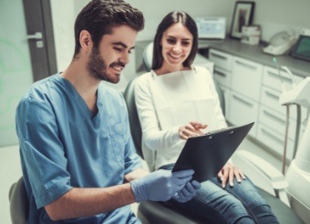 Dentist and patient looking at digital images on tablet computer