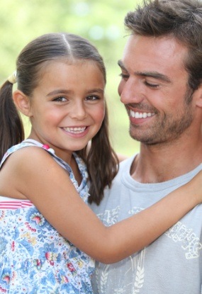 Father and child smiling after preventive dentistry visit