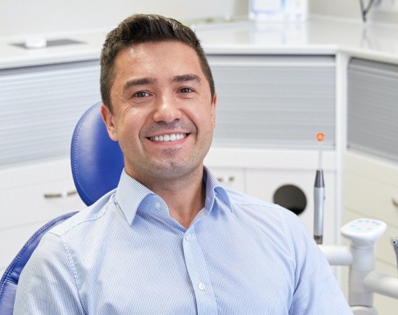 Man smiling during dental checkup and teeth cleaning visit