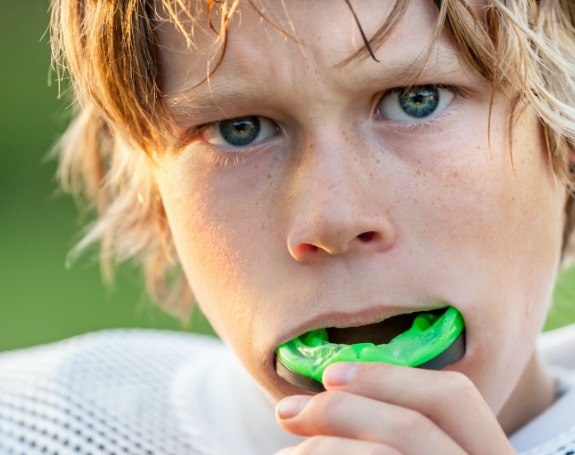 Teen placing a green sportsguard