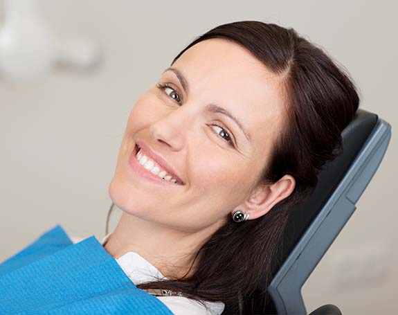 Woman smiling after fluoride treatment