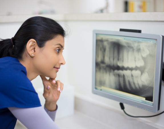 Dental team member looking at digital x-rays