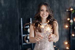 a woman smiling happily for the new year