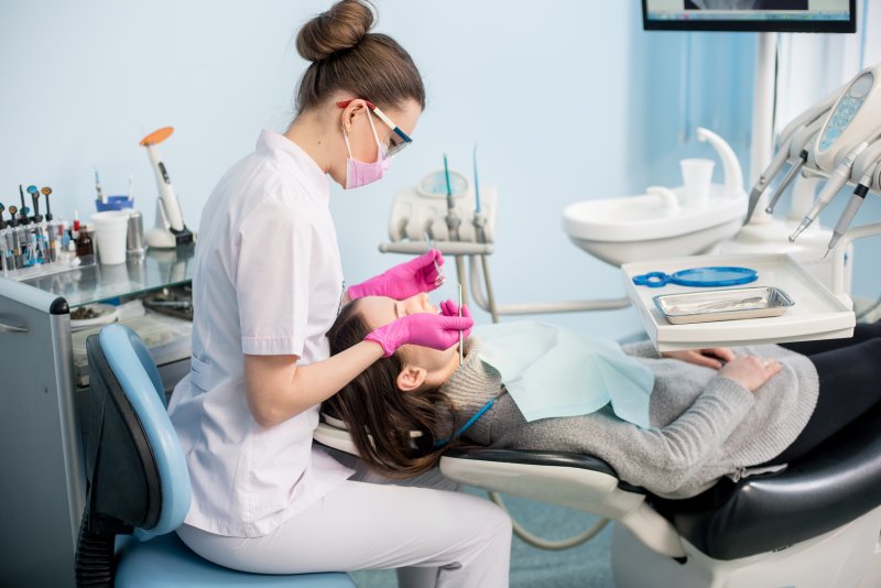 A dental hygienist working on a patient