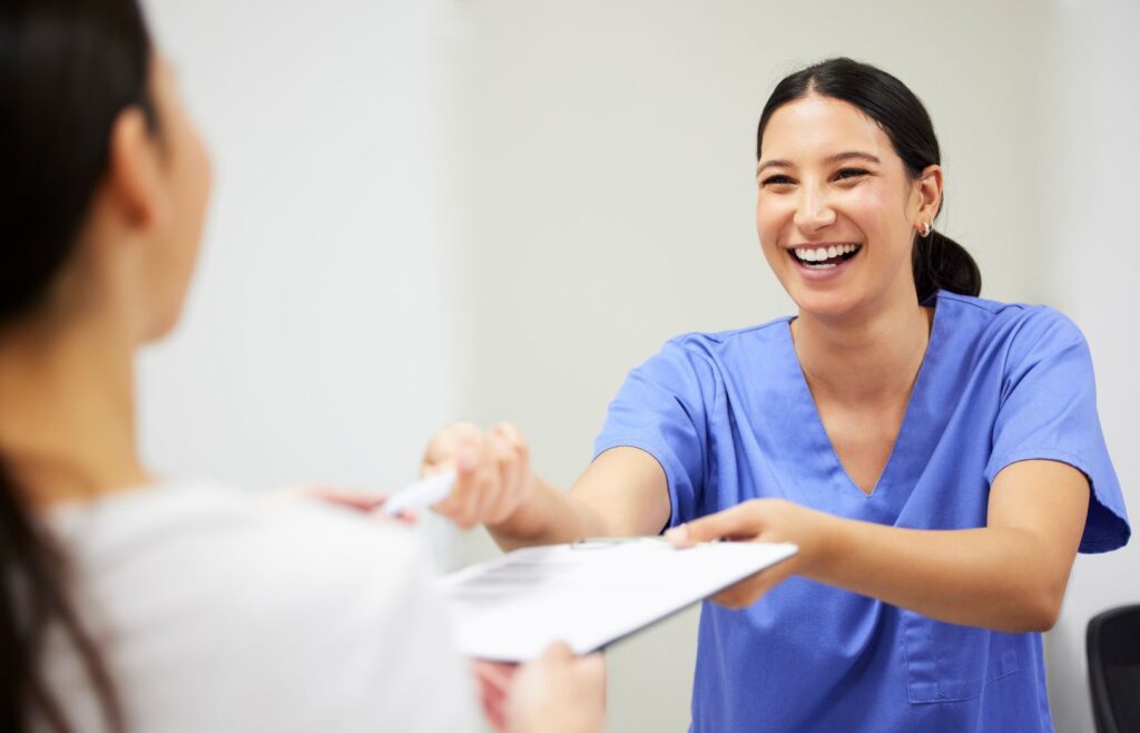 A woman paying at the dentist’s office